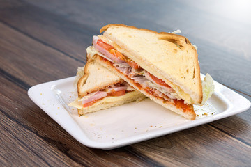 Sandwich with tomatoes and bacon on plate. Breakfast, food phto concept