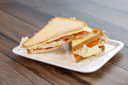 Sandwich with tomatoes and bacon on plate. Breakfast, food phto concept