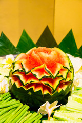 The water melon and the vegetables are  in a dish.