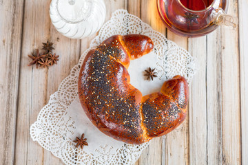 Baked cake with tea spot on wooden table