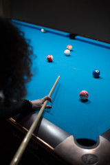 pool stick in hands breaking balls on table 