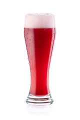 Red cherry beer kriek with drops and foam in glass. isolated