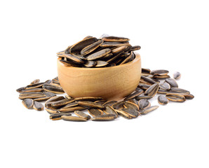 sunflower seedsin wooden bowl  isolated on white background