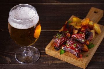 Beer and pork spare ribs with fry. Beer and meat. Glass of ale. horizontal