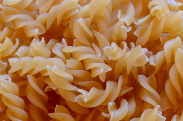 Macro photo of natural organic pasta "Fusilli Mini" of durum wheat for background