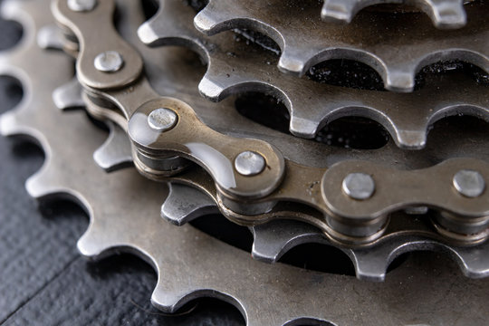 A gear and chain on a workshop table. Oiling and repair of bicycle drive.