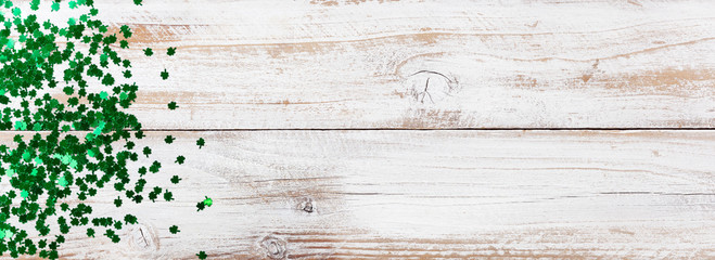 Bright green shamrock for Saint Patrick Day on white rustic wood