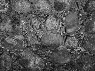 Wall of clay and stones close-up. Cobblestone Wall