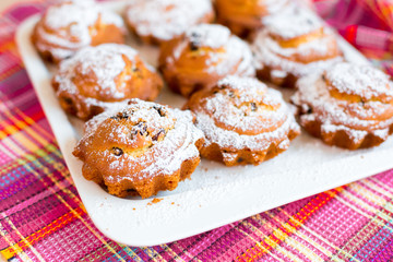 Delicious cakes on desk with sugar and raisins. Food photo for menu