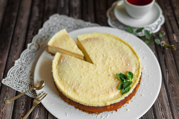 Cheese cake on white plate with mint. Sugar dessert, photo for menu