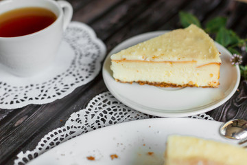 Cheese cake on white plate with mint. Sugar dessert, photo for menu