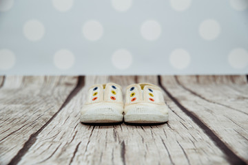 Bright children's slippers. On a light, pastel blue background, there are cream slippers for...