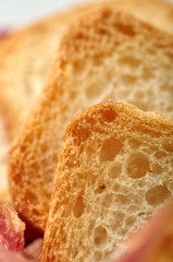 Beautiful texture of white porous bread. Close-up wheat bread as a substrate for a website, for a menu, for a postcard, for advertising. Delicious sandwiches for breakfast, lunch, dinner.