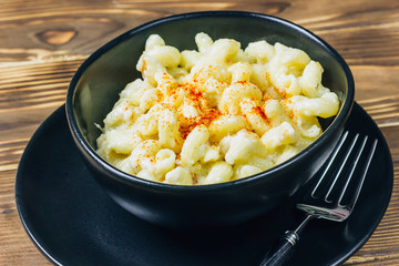 Classic Homemade Macaroni and Cheese on black bowl