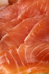 Texture from cold cuts close up. Thin slices of meat, red fish for a snack for a festive table, buffet, party. Fish, meat tartar for a snack, breakfast, lunch, dinner.