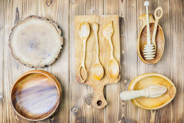 Collection of wooden kitchen utensil, bowl, plate, spoon, dish.