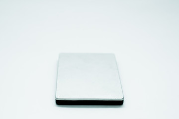 Gray portable hard drive. The concept of data storage on an external medium. Backing up files, protecting files.