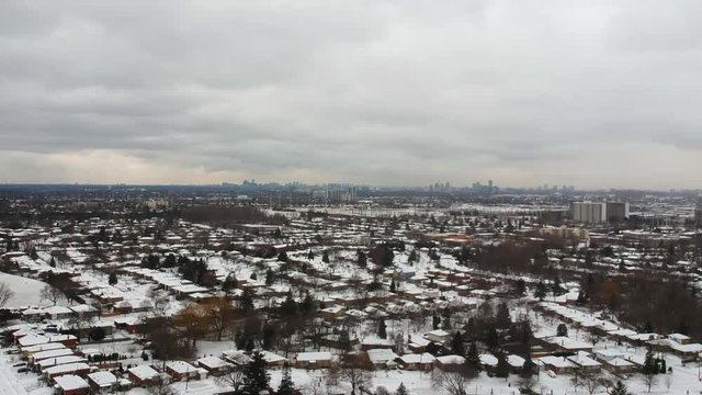 Aerial bird eye view skyline at Winter season in  America. Hundreds of low and high rise houses from top view in the background covered in high level of snow.