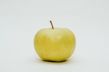 Fresh green apple isolated on white. Delicious apples lie on the table. The concept of providing vitamins along with fruits. Eating fruit on a daily basis.