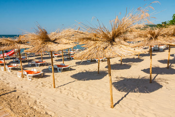 Straw umbrella on empty seaside beach, Bulgaria
