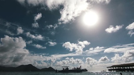 Seascape. Silhouette of tourists in a boat - Powered by Adobe