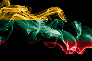 National flag of Lithuania made from colored smoke isolated on black background. Abstract silky wave background.