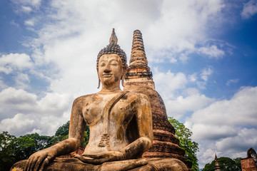 Fototapeta premium Buddha statue sitting in the Sukhotai Historical Park, Thailand