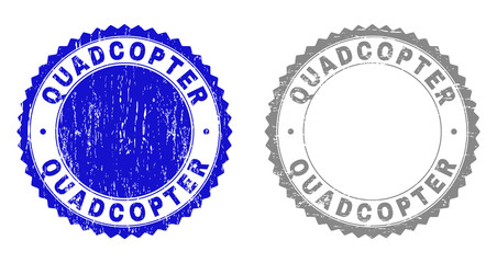 Grunge QUADCOPTER stamp seals isolated on a white background. Rosette seals with grunge texture in blue and gray colors. Vector rubber stamp imprint of QUADCOPTER label inside round rosette.