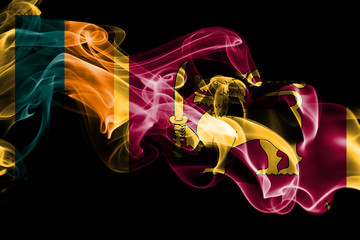 National flag of Sri Lanka made from colored smoke isolated on black background. Abstract silky wave background.