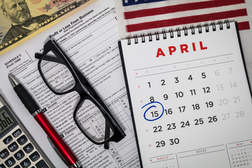 Filing Taxes still life business finance concept with calculator and tax forms, flat lay