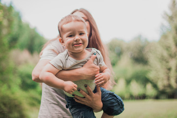 Mother play with son in the park.