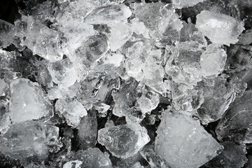 Crushed ice on black background, top view