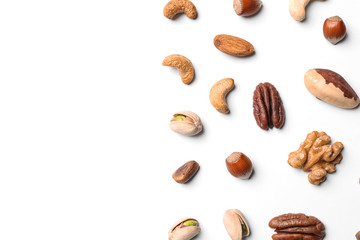 Composition with organic mixed nuts on white background, top view. Space for text