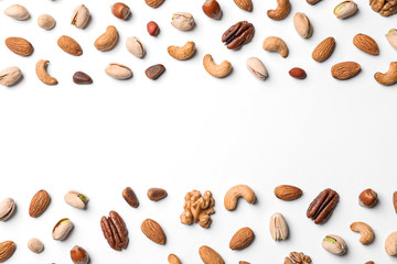 Composition with organic mixed nuts on white background, top view. Space for text