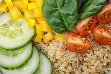 Healthy quinoa salad with vegetables as background