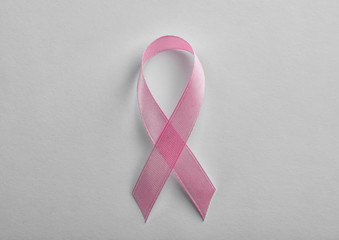 Pink ribbon on white background, top view. Breast cancer awareness concept