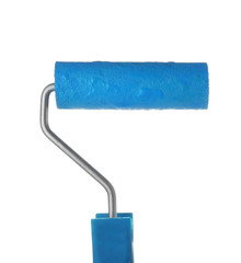 Obraz premium Roller brush with blue paint on white background