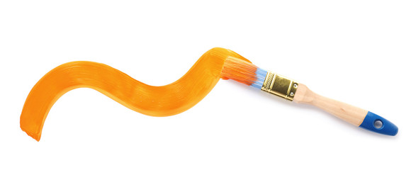 Brush with orange paint on white background, top view