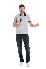 Handsome man in casual clothes posing with microphone on white background