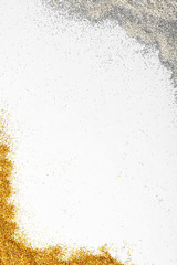 Frame made of silver and golden  glitters on white background, top view with space for text