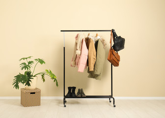 Stylish hallway interior with clothes on hanger stand
