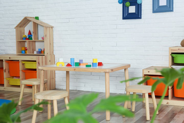 Modern child room interior with table and stools