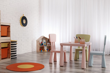 Modern child room interior with table and chairs