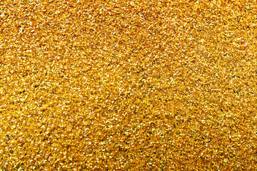 Texture of gold glitter as background, closeup