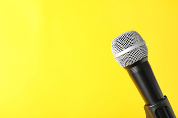 Dynamic microphone on color background, space for text