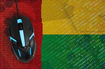 Guinea Bissau flag and computer mouse. Digital threat, illegal actions on the Internet