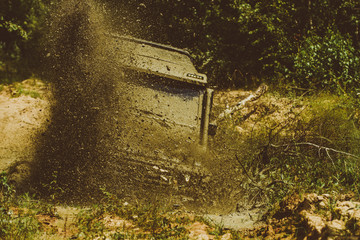 Off road sport truck between mountains landscape. Drag racing car burns rubber. Extreme. Off-road car. Track on mud. 4x4 Off-road suv car. Offroad car. Safari.
