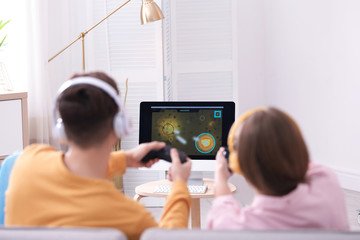 Young couple playing video games at home