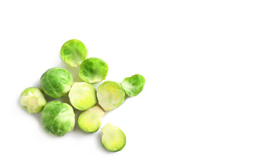 Fresh Brussels sprouts and leaves on white background, top view