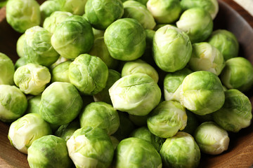 Tasty fresh Brussels sprouts in bowl, closeup